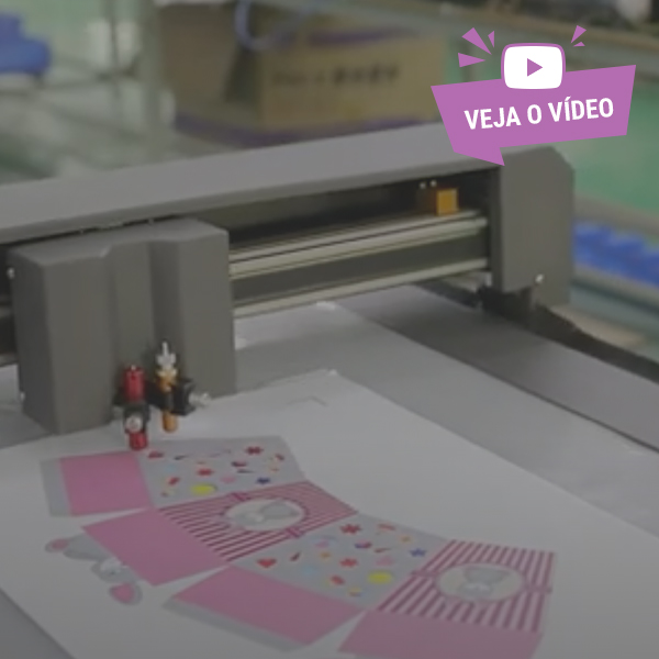 Plotter de mesa a vácuo a cortar embalagens personalizadas em papel. Botão 'Veja o vídeo' no canto superior direito.